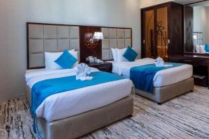 เตียงในห้องที่ Palm Inn Hotel Doha