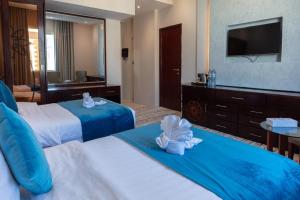 เตียงในห้องที่ Palm Inn Hotel Doha