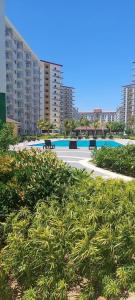 a view of a resort with a pool and buildings at Field Residences Condo Hotel in Manila +18 photos