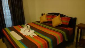 a bed with a stuffed animal on top of it at Baan Peaceful Villa 1, Ao Nang in Krabi town