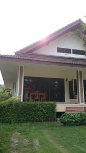 a house with a table in the back yard at Baan Peaceful Villa 1, Ao Nang in Krabi town