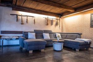 a living room with a couch and a table at Luxury Chalet Martin in Grosuplje