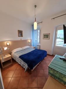 Postel nebo postele na pokoji v ubytování Albergo Genio