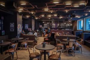 a restaurant with tables and chairs and a bar at Revier Mountain Lodge Saas-Fee in Saas-Fee +37 photos