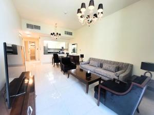 a living room with a couch and a table at Polo Residence Building C1 in Dubai