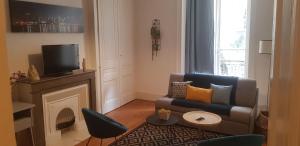 a living room with a couch and a fireplace at Le Couvent Saint Vincent in Lyon