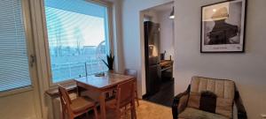 a room with a table and a chair and a window at Cozy apartment with view in Kajaani