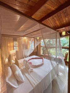 a bed in a room with a glass ceiling at Mountain Breeze Wooden Cottages in Agonda +52 photos