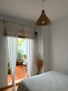 a bedroom with a bed and a view of a patio at Azahares Apartamento turístico in El Bosque