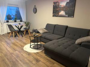 a living room with a couch and a table at Ferienwohnung Schönheit in Gönnern