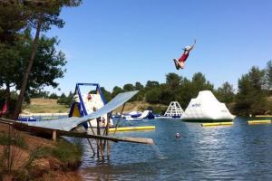 a bird flying over a lake with boats in the water at Beautiful architectural villa 10 pool beds in Laure-Minervois