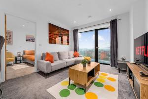 a living room with a couch and a table at Modern Luxurious Central Apartment in Manchester