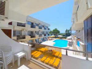 an apartment with a balcony with a swimming pool at Mulka Hotel in Ayvalık