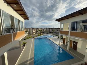 a swimming pool in the backyard of a house at Velmiro Greens dauis Panglao - 3 bedroom apartment unit P1112 in Dauis