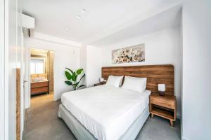 a white bedroom with a large bed and a bathroom at Kamelia Villa 1 in Hersonissos +36 photos