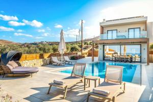 a villa with a swimming pool and a house at Kamelia Villa 1 in Hersonissos
