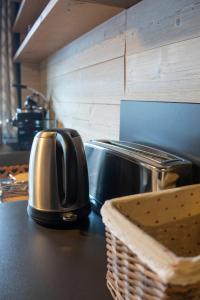 a toaster sitting on a counter in a kitchen at Résidence VAL VILLAGE, skis aux pieds, Duplex 3 chambres 75 m2 - by MONTBLANC LODGE in Val dʼIsère