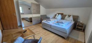 a small bedroom with a bed and a chair at Ferienwohnung Pirker in Spittal an der Drau