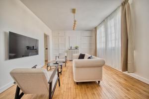 a living room with a couch and a table at Magnolia in Épernay