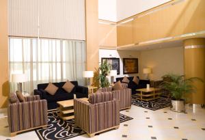 a living room with couches and chairs in a room at Copthorne Al Jahra Hotel & Resort in Kuwait