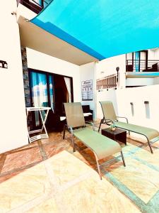 a living room with two chairs and a table at Mont Oreb Villas Onyx Flic en Flac in Flic-en-Flac