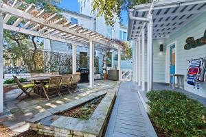 a patio with a table and a pergola at Just for Fun 2 in Santa Rosa Beach