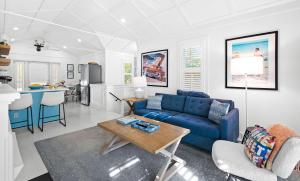 a living room with a blue couch and a table at Just for Fun 2 in Santa Rosa Beach