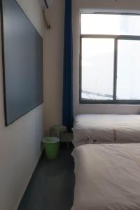 Postel nebo postele na pokoji v ubytování Sanya Luyu B&B