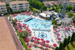an aerial view of a resort pool with umbrellas and chairs at Villaggio Planetarium Resort in Bibione