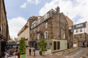 an old building in the middle of a street at The Edinburgh Rooftop Terrace in Edinburgh