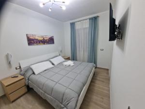 a bedroom with a large bed and a television at Greta family house in Rome