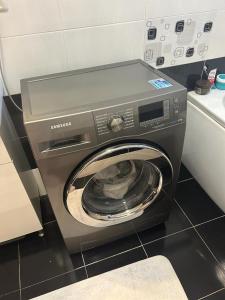 a washing machine with its door open in a kitchen at Lux studio 46 meters in Colentina