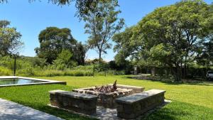a fire pit in the middle of a park at Loto San Lorenzo Studio I balcón, vista cerros y piscina in San Lorenzo