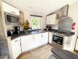a kitchen with white cabinets and a sink at Ferienhaus Sabine in Sassenberg