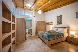 a bedroom with a bed and a bathroom at Archanes Philoxeno Appartment in the Village in Archanes
