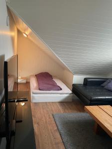 a small room with a bed and a couch at Hytta in Bømlo