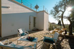 a patio with two chairs and a table on a patio at Borgo Antico - Casa White Tellaro P1 in Tellaro