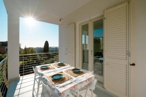 a table on the balcony of a house at Borgo Antico - Casa White Tellaro P1 in Tellaro