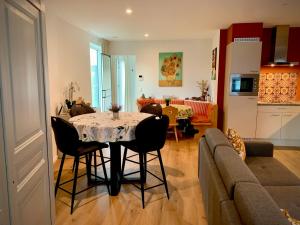 a kitchen and a living room with a table and chairs at Olivia in Lier