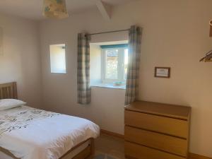 a bedroom with a bed and a window at The Milking Parlour in Llandeilo +16 photos