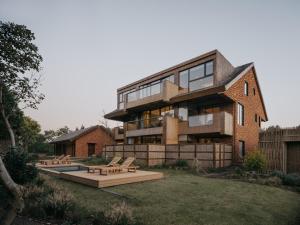 a large brick building with a yard with benches at Somland Resort in Paiya