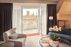a living room with a couch and a glass table at London Marriott Hotel County Hall in London
