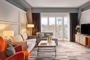 a living room with a couch and a table at London Marriott Hotel County Hall in London