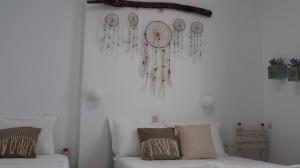a white room with a couch and some earrings at Pension Sofia in Parikia