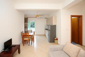 a living room with a couch and a table at Ionian Seaview in Himare
