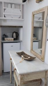 a mirror sitting on a table in a kitchen at Pension Sofia in Parikia