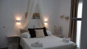 a bedroom with a bed with two towels on it at Pension Sofia in Parikia