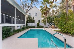 a swimming pool in front of a house at Delahunt Cottage - 4218 Seventh Street in Saint Simons Island
