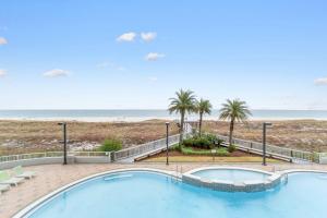 a swimming pool with the beach in the background at Spanish Key 705 in Perdido Key