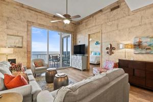 a living room with a couch and a television at Spanish Key 705 in Perdido Key